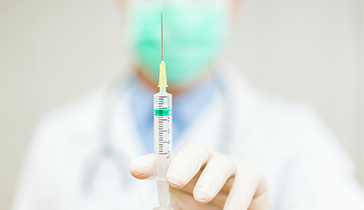 Close up of a doctor's hand holding a vaccine 